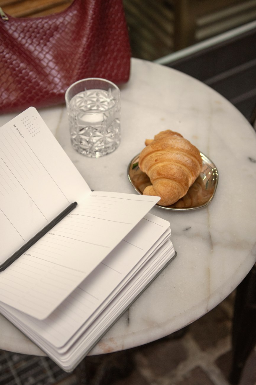 Notebooks and coffee on a marble table